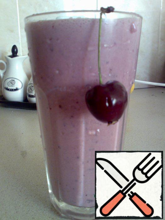 Add the milk and beat again. Serve over ice in large glass, garnish with a cherry.