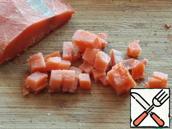 Cut into small cubes salted salmon.