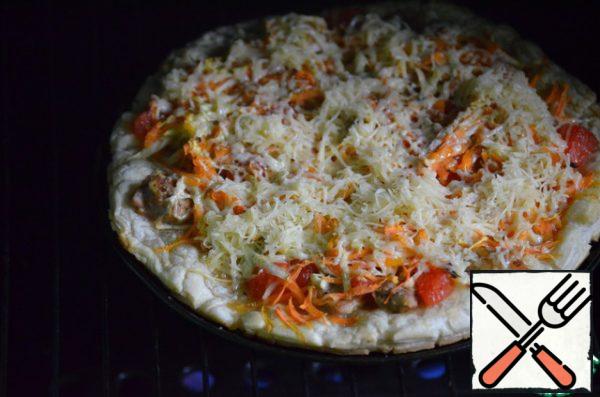 Then take out the pizza, sprinkle with grated cheese and bake for another 10-15 minutes.
