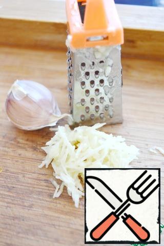Grate the garlic on a small grater.