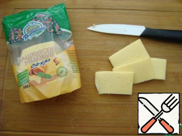 We'll need some hard cheese. Cut it into smaller pieces of dough.
