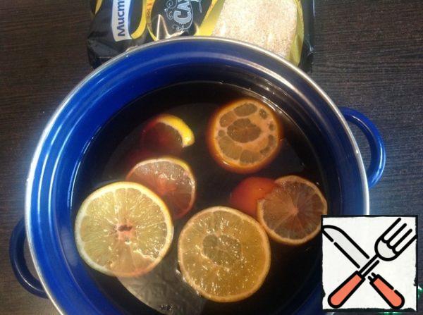 In wine add strained spicy broth, coffee, half slices of lemon and orange. Warm mulled wine on low heat for 15 minutes without boiling. Remove from heat and pour the brandy.