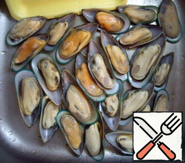 Take a sufficient number of mussels and put them under cold water for defrosting - I usually have one pan fit 32 mussels.