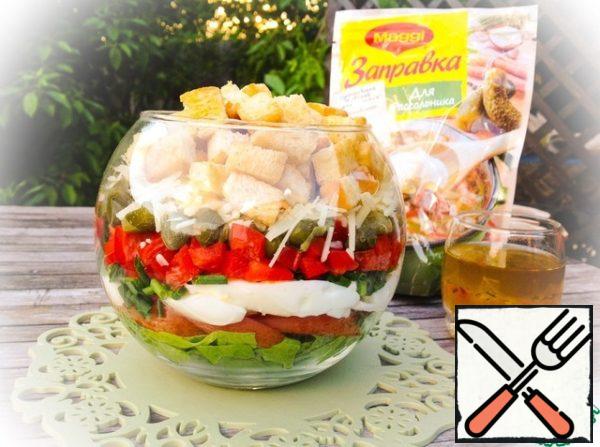 Put vegetables, eggs, capers and cheese in a salad bowl layer by layer. Pour the prepared dressing over the salad. To interfere. Put the croutons on top.