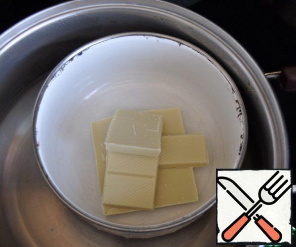 White chocolate is melted in a pan of barely simmering water.