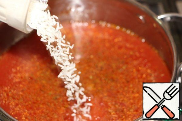 Rinse the rice and pour it into boiling tomato broth. Bring to a boil, cook for 10 minutes on low heat.
