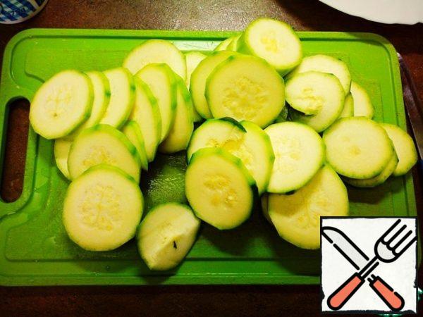 Zucchini peel and cut into rings of medium thickness (they should not break from the subtleties, but also to be very thick, too)