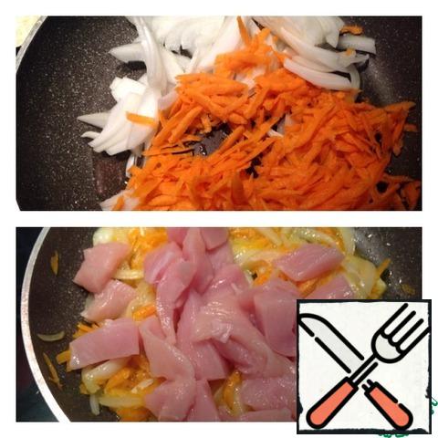 Onions cut into half rings, carrots grate on a coarse grater. Fry the vegetables in vegetable oil until almost ready. Chicken breast cut into cubes and add to the vegetables. The fire is strong enough. Stir the Breasts with vegetables and fry for 7 minutes with the lid closed.