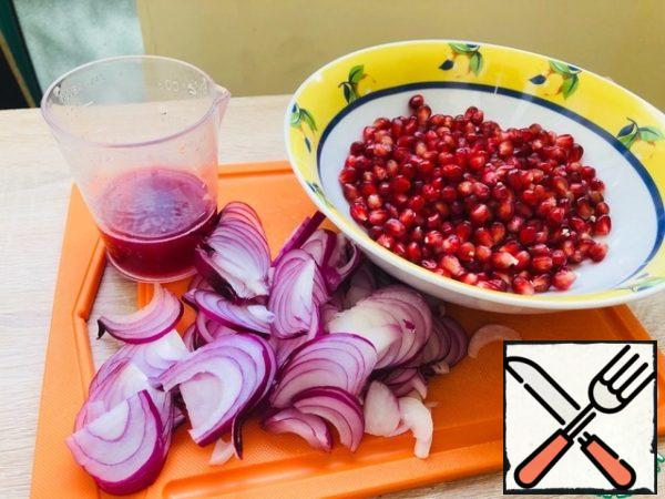 Peel the red onion and cut into thin half-rings. Soak in cold water with 1 teaspoon of salt for at least 20 minutes. Fold in a colander, allow to drain.
Pomegranate cut in half. More than half of extract of grain. From the second half, press the juice.