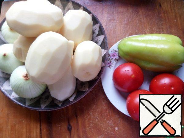 At this time, the vegetables clean, wash and cut.
Onion half-rings.
Potatoes large plates, up to 1cm thick.
Bell pepper into 4 pieces.
Cut the tomatoes into slices.
The garlic in thin plates.
