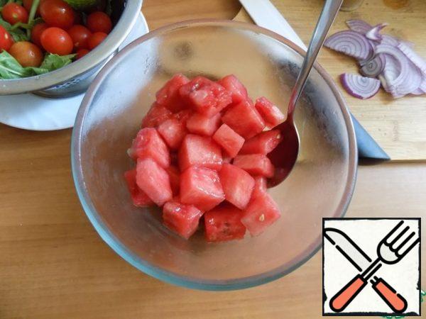 Remove the pieces of watermelon from the freezer and pour them all over the dressing. Mix, and other vegetables. Cut onion into thin half-rings.