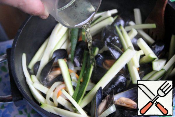 Add ouzo, wine, fish broth (I have it pre-frozen), salt, pepper, bay leaf. Simmer on low heat for 4-5 minutes.
