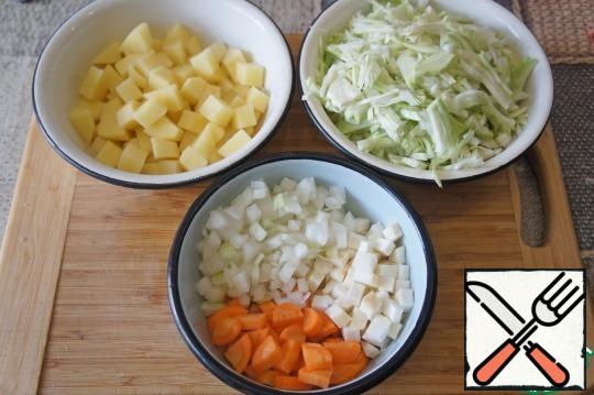 Similarly, cut 2 raw potatoes, onion and carrots, finely chop 300 g of cabbage.