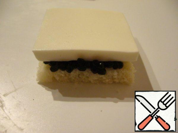 Form a canape in layers: a layer of bread, then cover with a thin layer of cream cheese, caviar, cheese, bread, cream cheese, caviar, cheese. Tie a bow on each canape, attach an onion bow to the skewer on top.
