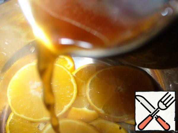 Wash the oranges and cut into thin circles, put in a pan and pour hot freshly brewed coffee.