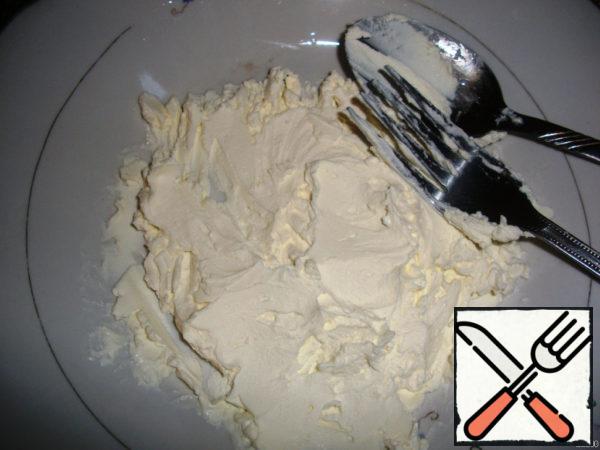 Cream cheese mash with a fork.