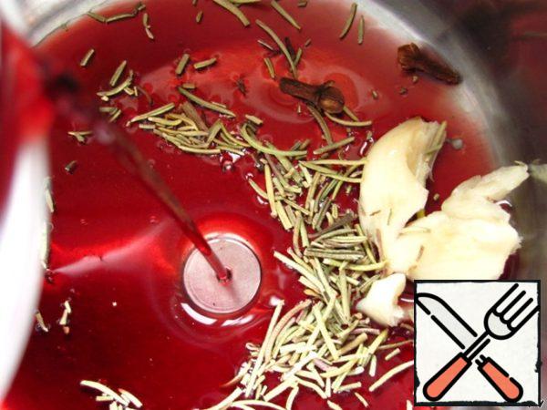 In a small saucepan, combine the remaining wine, garlic, cloves and rosemary.