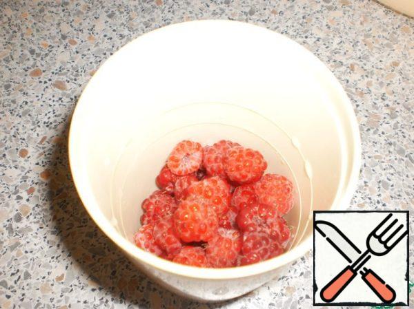 Put the raspberries in a blender.
