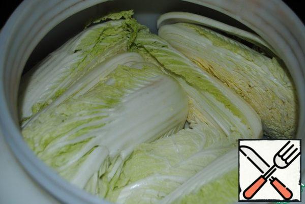 Cabbage is taken so much, because it is prepared for the whole year.
The heads are cut into two equal parts and placed in a barrel for food.