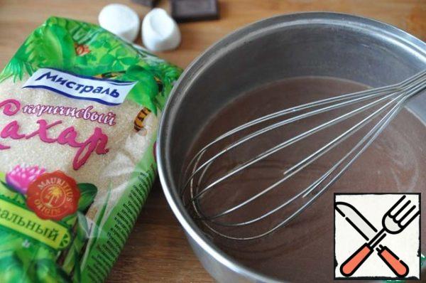 Pour the hot milk into the chocolate and mix with a whisk.
