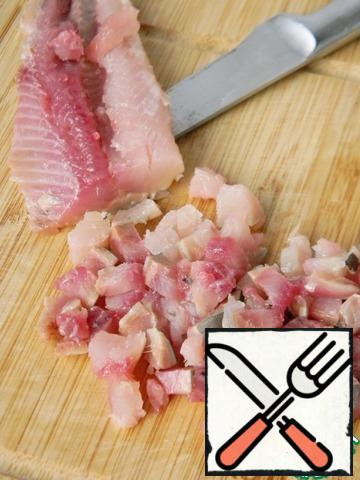 Cut herring fillet into cubes.