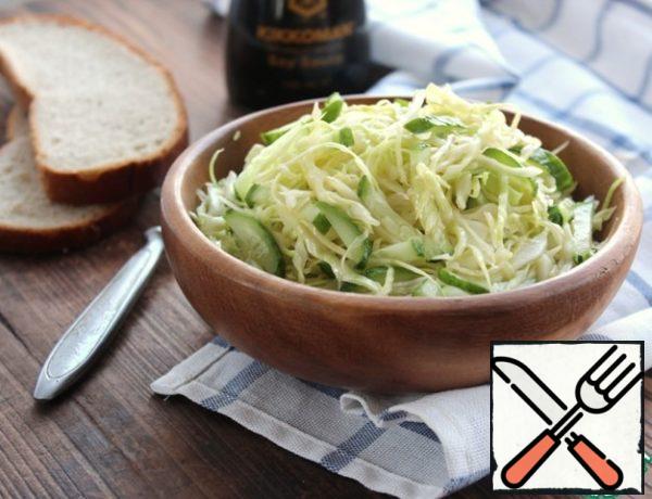 Season the cabbage with cucumbers, mix the salad. That's it!