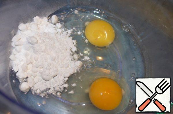 Beat eggs with powdered sugar to form a white foam.
