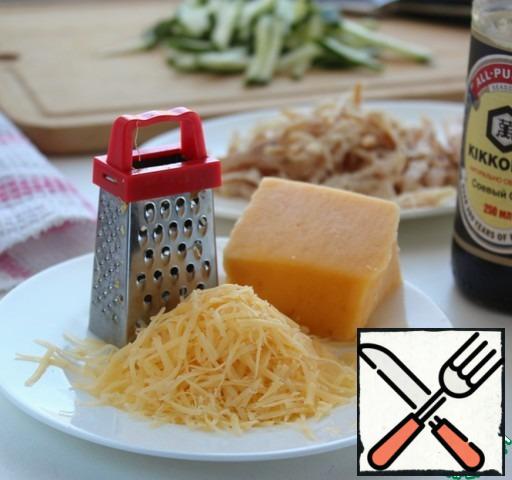 Grate cheese on a grater.