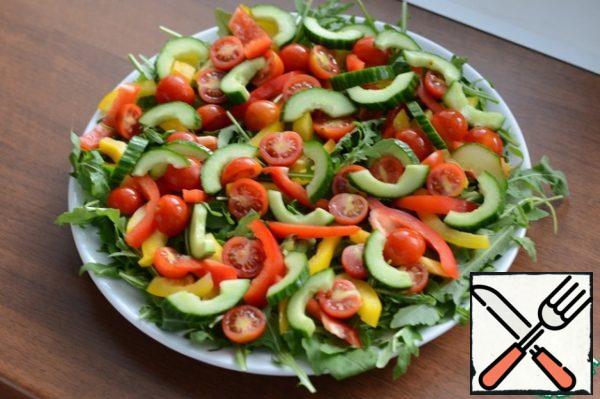 Put the chopped vegetables on the arugula. Arbitrary.
