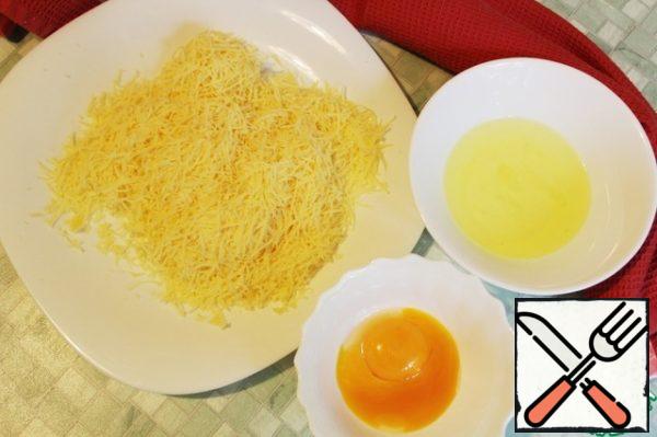 Grate cheese on a medium grater, separate the yolks from the whites (from two eggs).
