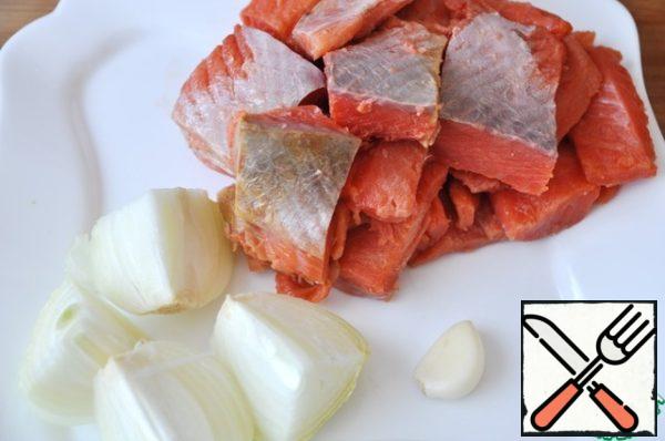 To prepare, take any fish of the salmon species, I have coho salmon. Fish clean, cut into fillets, cut into pieces, also clean and cut onions and garlic.