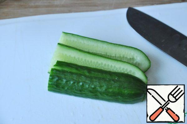Cut the cucumber lengthwise into thin strips.

