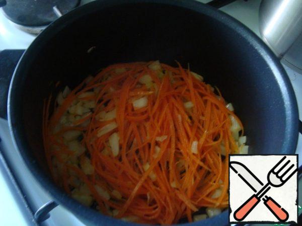 Onions and carrots put into the heated oil in the skillet, slightly roasted.
