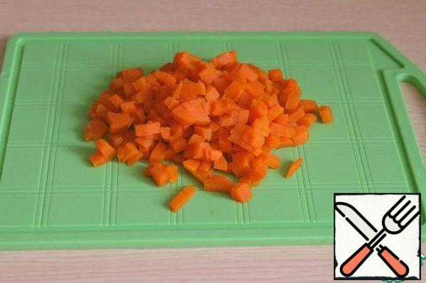 Boil carrots, cut into small cubes.