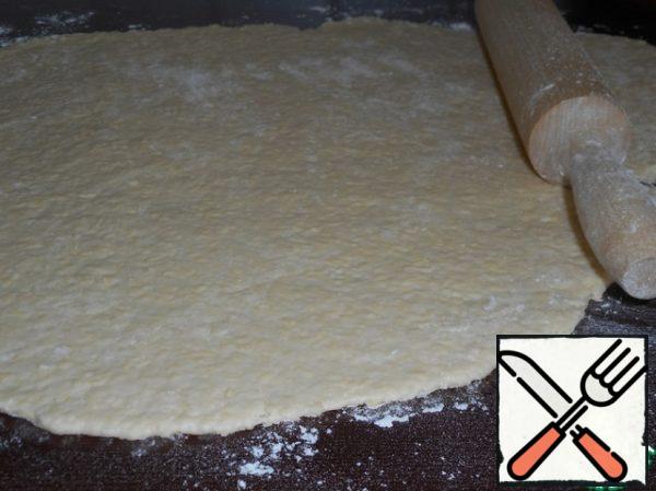 Using a rolling pin roll out the dough.
