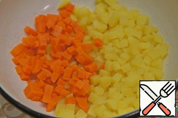 Cut into small cubes boiled and peeled carrots and potatoes.