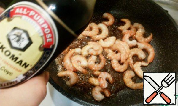 Add Kikkoman soy sauce. It will give a piquant taste to shrimp. Evaporate the sauce for 2-3 minutes stirring. 