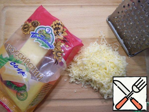 Grate the cheese on a medium grater.
