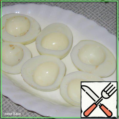 Boil an egg, cut it in half, pull out the yolks.