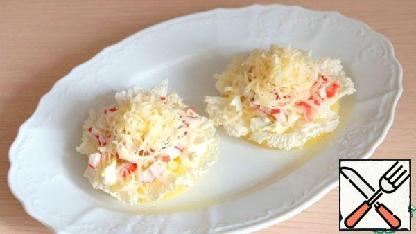 On top of the salad, sprinkle with fine shredded cheese.