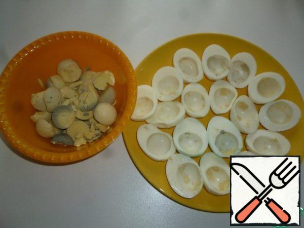 Eggs cut in half, separate whites and yolks.