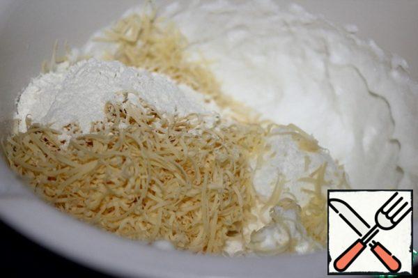 Beat the cold whites to stiff peaks, add grated cheese and flour.
