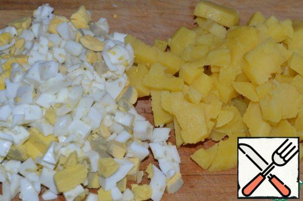 Potatoes and eggs are also cut into cubes.