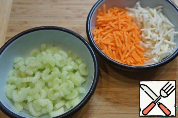 Meanwhile, prepare the vegetables. Chop carrots and celery into thin strips, cut celery stalks into slices.