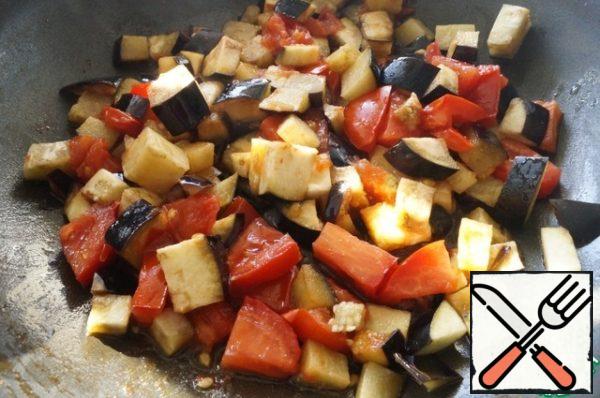 Prepare the filling: wash the eggplant and tomato and cut into cubes. Heat some vegetable oil in a frying pan. Put the vegetables and simmer until soft. Salt and stir.