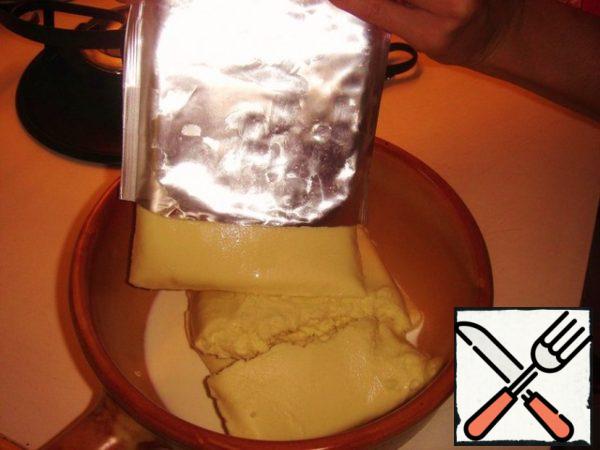 Put contents in fondue pot.
If you use hard cheese, then rub it on a grater and add half a glass of hot white wine.