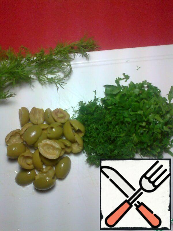 Grind the greens. Olives can be put an entire, and can be cut in half.