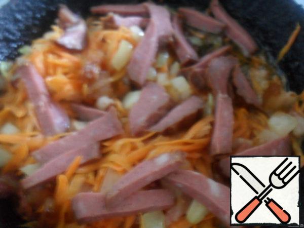 When the onion is Golden, add chopped cubes, or diced smoked sausage.