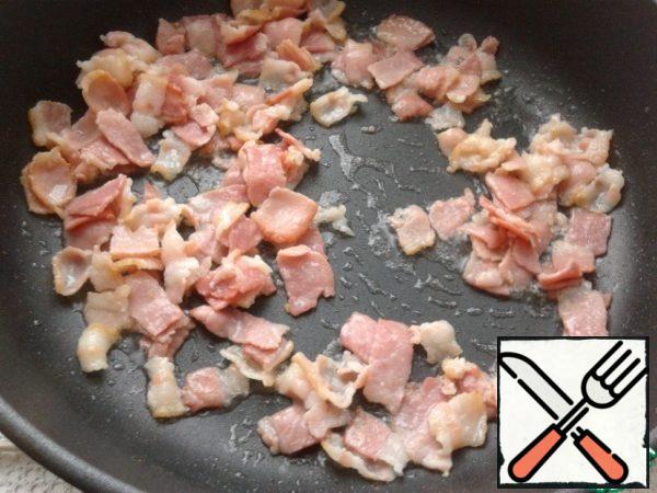 Bacon cut into strips. Fry in a pan (do not add oil).