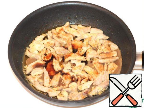 We send pork to the frying pan. Fry until golden brown over high heat, stirring constantly. Add garlic, soy sauce and sugar to the meat.
